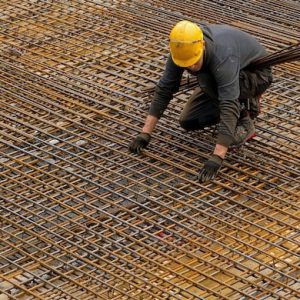 Worker aligning pipes - SCR Safety Solutions