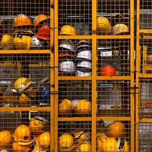 Yellow hard hats in a cage - SCR Safety Solutions